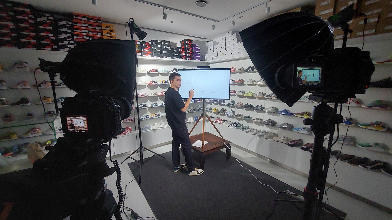 Interview-Setup im Sneaker-Laden: zwei Kameras, Softbox, Protagonist am Bildschirm.